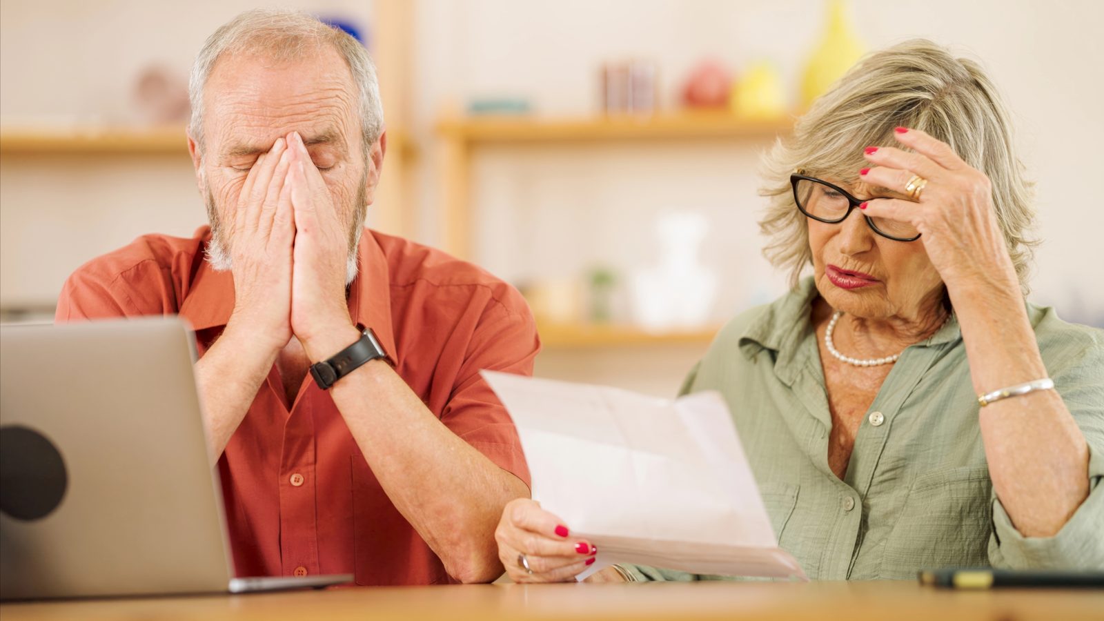 A couple feeling overwhelmed by the paperwork of their financial life