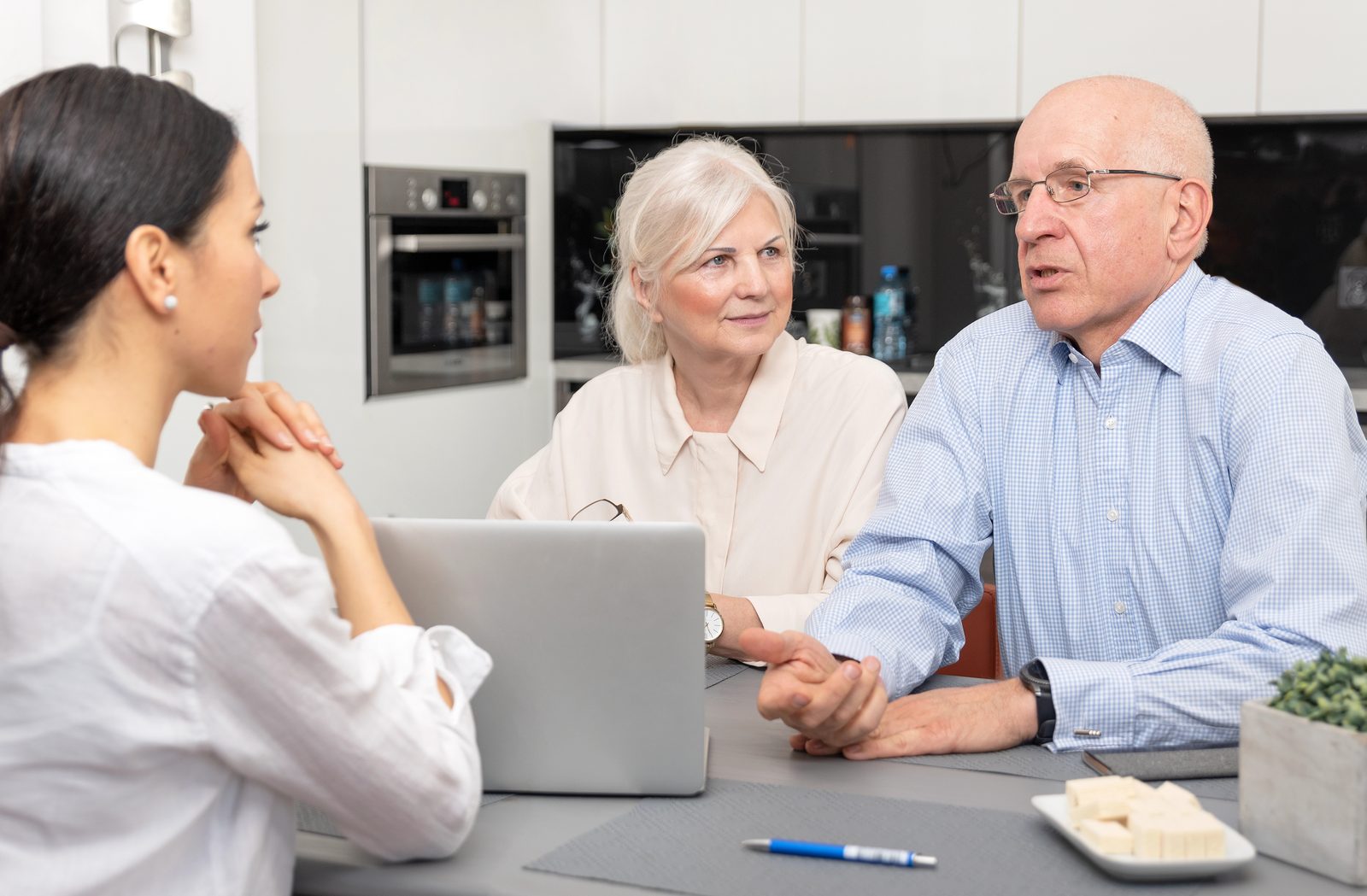 A Persynl Service Advisor working through documents with a senior couple